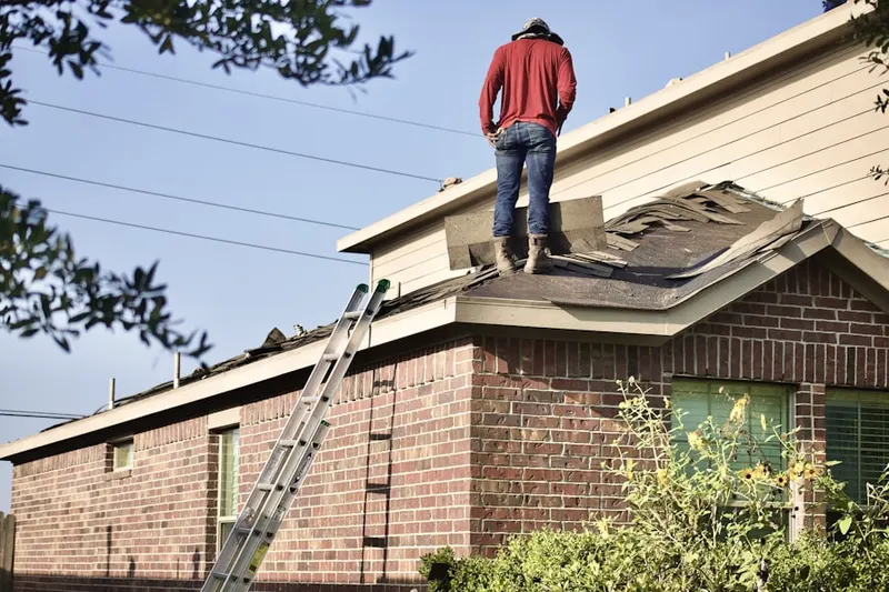 Professional roofer working on a residential roof in Cypress Woods